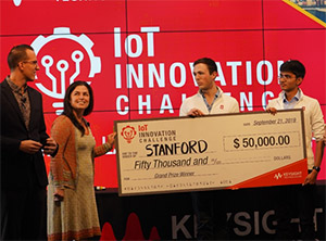 Left: Daniel Bogdanoff (far left), Keysight Master of Ceremonies, and Marie Hattar, Keysight CMO (second left), present Max Holiday and Anand Lalwani (far right) of Stanford with the Grand Prize in the Keysight IoT Innovation Challenge.