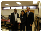 Santa Clara University and Agilent representatives with commemorative plaque for SCU electrical engineering undergraduate teaching lab.